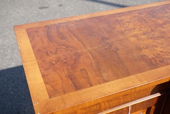 A reproduction George III style banded burr walnut breakfront side cabinet, width 154cm, depth 50cm, height 90cm